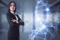 Attractive young european businesswoman with folded arms and abstract glowing DNA hologram in blurry office interior. Medicine,
