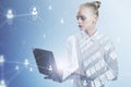 Attractive young european businesswoman using laptop computer with abstract glowing people and light bulb network on blurry Royalty Free Stock Photo