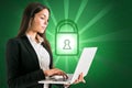 Attractive young european businesswoman using laptop with glowing padlock on coding background. Digital safety, security,