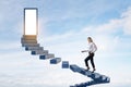 Attractive european female climbing sky stairs to success and opprtunity with open door and mock up place Royalty Free Stock Photo
