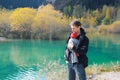 Attractive young father with her infant baby in sling outdoor. Babywearing concept Royalty Free Stock Photo