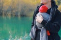 Attractive young father with her infant baby in sling outdoor. Man is carrying her child and travel in autumn mountain Royalty Free Stock Photo