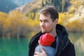 Attractive young father with her infant baby in sling outdoor. Babywearing concept Royalty Free Stock Photo