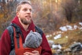 Attractive young father with his infant baby in sling fall outdoor. Man is carrying her child and travel in nature Royalty Free Stock Photo