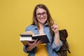 Attractive young female college student carrying a stack of books. Royalty Free Stock Photo