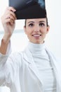 Attractive young female doctor examining x-ray results Royalty Free Stock Photo