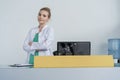 Attractive young female doctor leaning on the clinic reception desk, medical staff and healthcare concept. Royalty Free Stock Photo