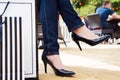 Attractive young female in black high heels enjoying a break after successful shopping Royalty Free Stock Photo