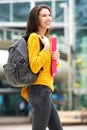 Attractive young female student walking to class with book bag Royalty Free Stock Photo