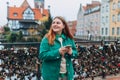 Attractive young female tourist is exploring new city. Gdansk old town, A happy woman is standing near Radunia Canal Royalty Free Stock Photo