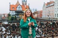 Attractive young female tourist is exploring new city. Gdansk old town, A happy woman is standing near Radunia Canal Royalty Free Stock Photo