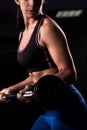 Attractive young fit sportswoman working out in gym lifting Royalty Free Stock Photo