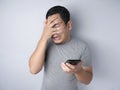 Young Man Texting Reading Chatting on His Phone Sad Crying Royalty Free Stock Photo