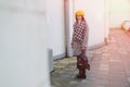 Attractive young girl in glasses in coat and yellow Beret freestyle walking