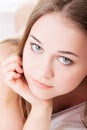 Attractive, young girl proping her bed. Royalty Free Stock Photo