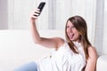 Attractive young girl shooting selfie with tongue out Royalty Free Stock Photo