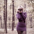 Attractive young girl taking photos in autumn park Royalty Free Stock Photo