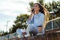 Attractive young girl talking on smartphone. Beautiful brunette woman communicates with friends using mobile phone. Royalty Free Stock Photo