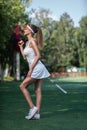 Attractive young girl with a tennis racket Royalty Free Stock Photo