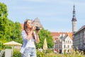 Attractive young girl traveling and exploring beautiful old town. Tourist with a retro camera on a vacation. Royalty Free Stock Photo