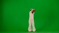 Attractive young girl in white outfit dancing showing dramatic contemporary dance on chroma key green screen background. Royalty Free Stock Photo