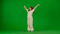 Attractive young girl in white outfit dancing showing elegant contemporary dance on chroma key green screen background. Royalty Free Stock Photo