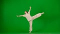 Attractive young girl in white outfit dancing showing flexible contemporary dance on chroma key green screen background. Royalty Free Stock Photo