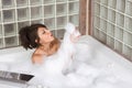 Attractive young gorges woman taking Bubble bath Royalty Free Stock Photo