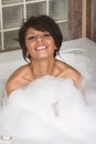 Attractive young gorges woman taking Bubble bath Royalty Free Stock Photo