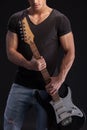 Attractive young guitarist with a musical Royalty Free Stock Photo