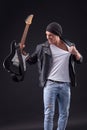 Attractive young guitarist is performing with Royalty Free Stock Photo