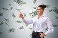 Attractive young happy businesswoman showing thumbs up with creative dollar bill rain on concrete wall background. Millionaire,