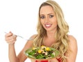 Attractive Young Happy Woman Eating a Fresh Healthy Prawn Salad