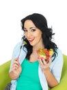 Attractive Young Heathy Woman Holding Up A Fresh Exotic Fruit Salad Royalty Free Stock Photo