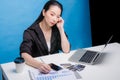 Attractive young housewife wearing shirt at home studying gas and electricity bills, checking calculations, looking at sheet of Royalty Free Stock Photo