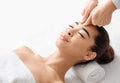 Attractive young korean woman receiving acupressure head massage in spa salon Royalty Free Stock Photo