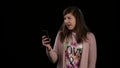 A Young Lady Gesturing Bingo and Using a Phone