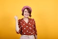 Attractive young lady looking funny and happy raising fist and shouting laughing