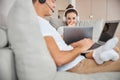 Attractive young lady working on laptop beside her boyfriend Royalty Free Stock Photo