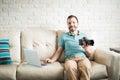 Hispanic man downloading photos on his computer