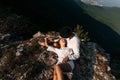 Attractive young loving couple of man and woman in the green mountain landscape Royalty Free Stock Photo