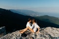 Attractive young loving couple of man and woman in the green mountain landscape Royalty Free Stock Photo