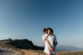 Attractive young loving couple of man and woman in the green mountain landscape Royalty Free Stock Photo