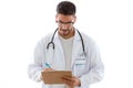 Attractive young male doctor with stethoscope over neck taking notes in clipboard isolated on white background. Royalty Free Stock Photo