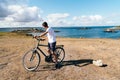 Attractive young male riding bicycle in the Island of Batz Royalty Free Stock Photo