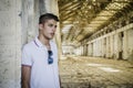 Attractive young man in abandoned, empty warehouse Royalty Free Stock Photo