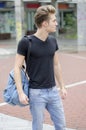 Attractive young man with backpack standing Royalty Free Stock Photo