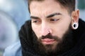 Attractive young man with beard and piercings Royalty Free Stock Photo