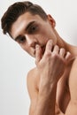 Attractive young man beautiful face bare shoulders brunet Royalty Free Stock Photo