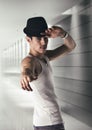 Attractive young man with black fedora in a Royalty Free Stock Photo